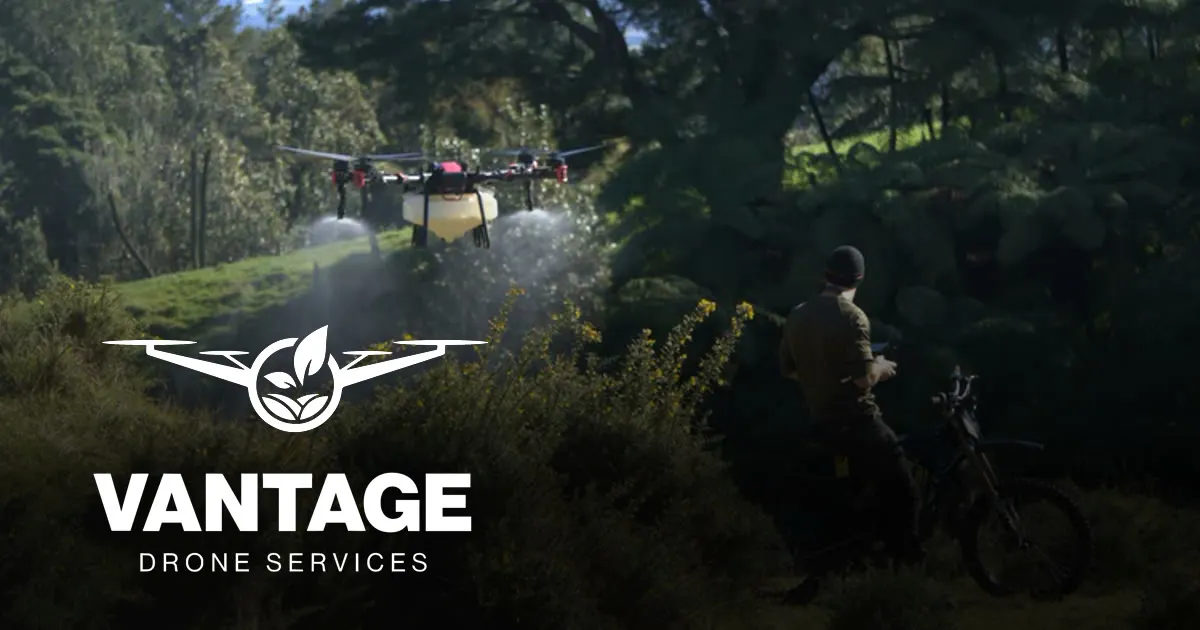 Vantage Drone Services spray drone in flight over Bay of Plenty bush with an operator on the ground